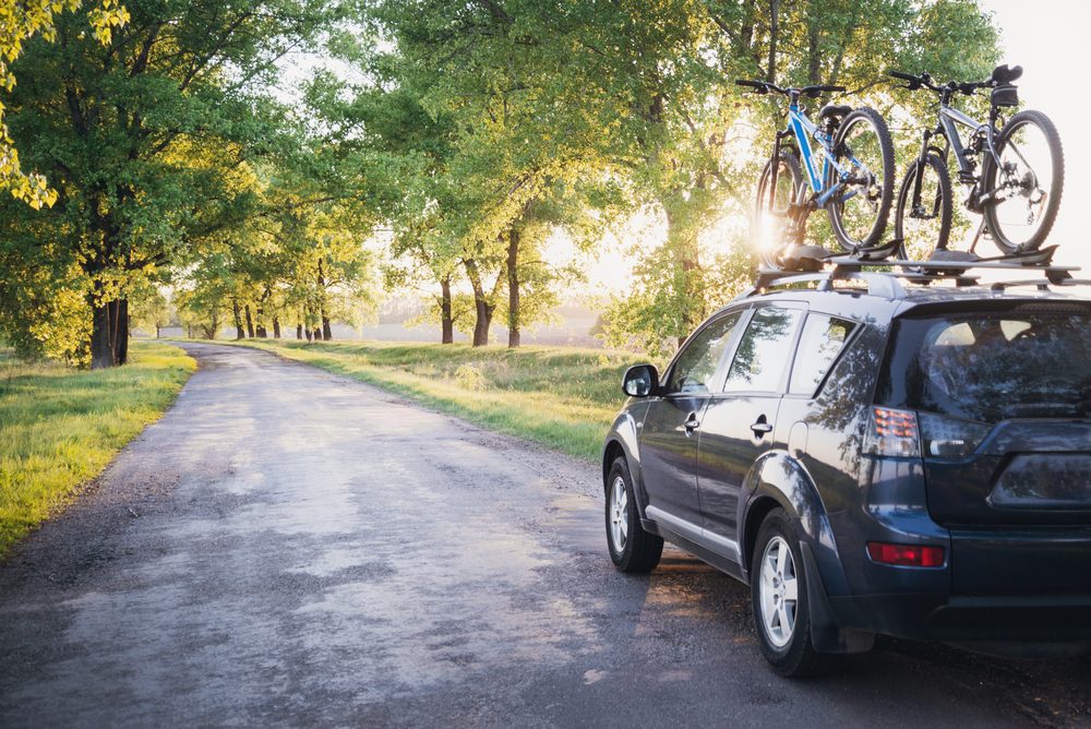 Car with bikes driving on a road