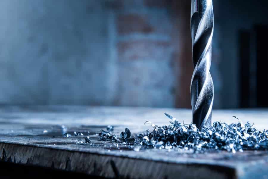 Close-up of a drill bit surrounded by metal shavings