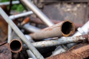Rusted metal pipes in a pile
