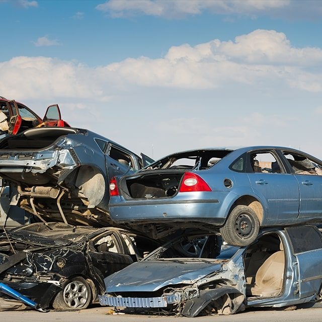 Cars piled up in a salvage yard