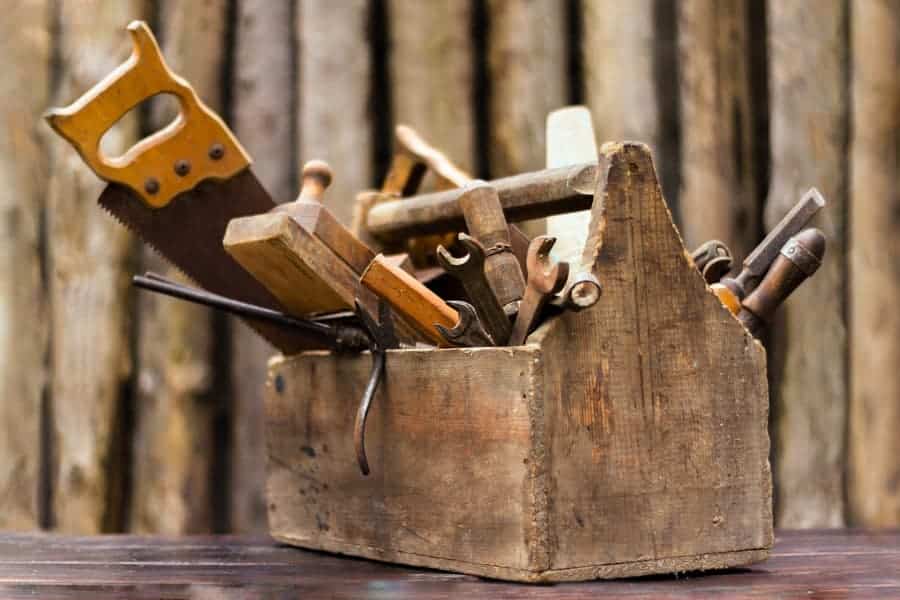 Wooden tool box filled with old tools that can be recycled